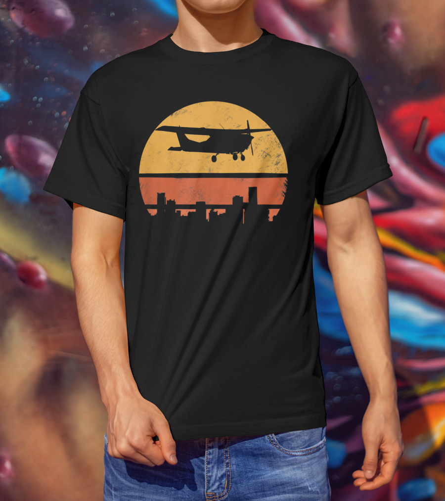 Retro Pilot C172 Flying Silhouette Over Sunset Cityscape T-Shirt