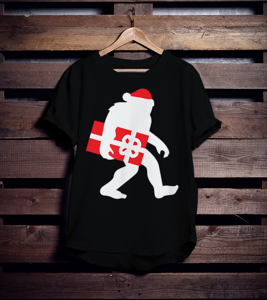 Nice Bigfoot Carrying Christmas Gift In Santa Hat T-Shirt