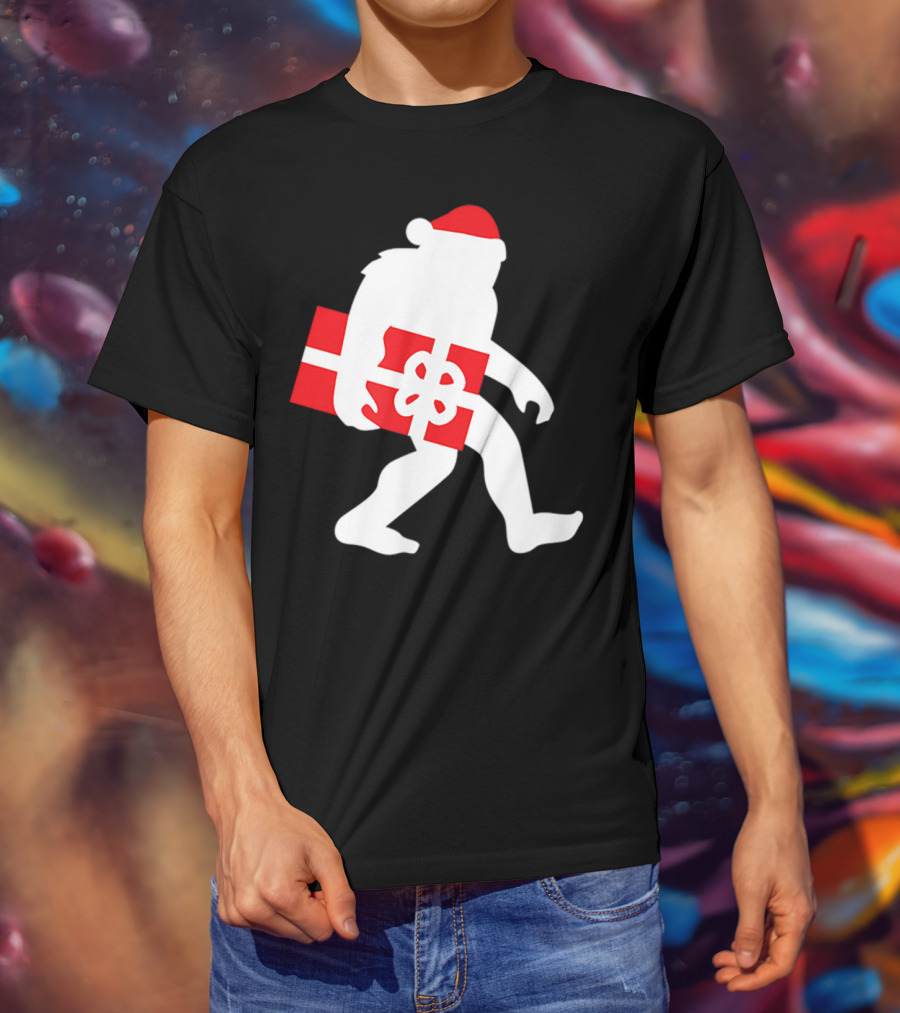 Nice Bigfoot Carrying Christmas Gift In Santa Hat T-Shirt