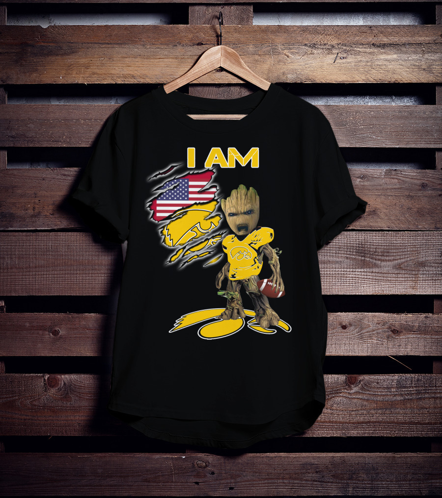 I Am Hawkeyes Baby Groot Holding Football With Usa Flag And Iowa Hawkeyes T-Shirt