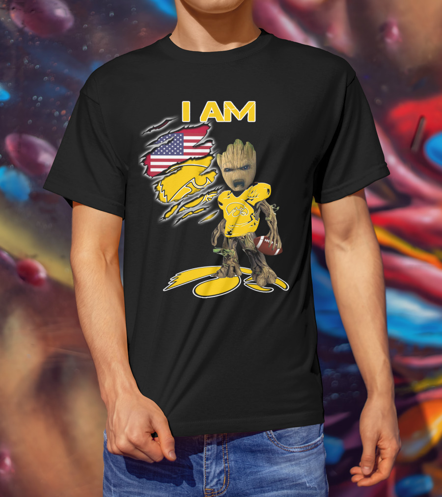 I Am Hawkeyes Baby Groot Holding Football With Usa Flag And Iowa Hawkeyes T-Shirt