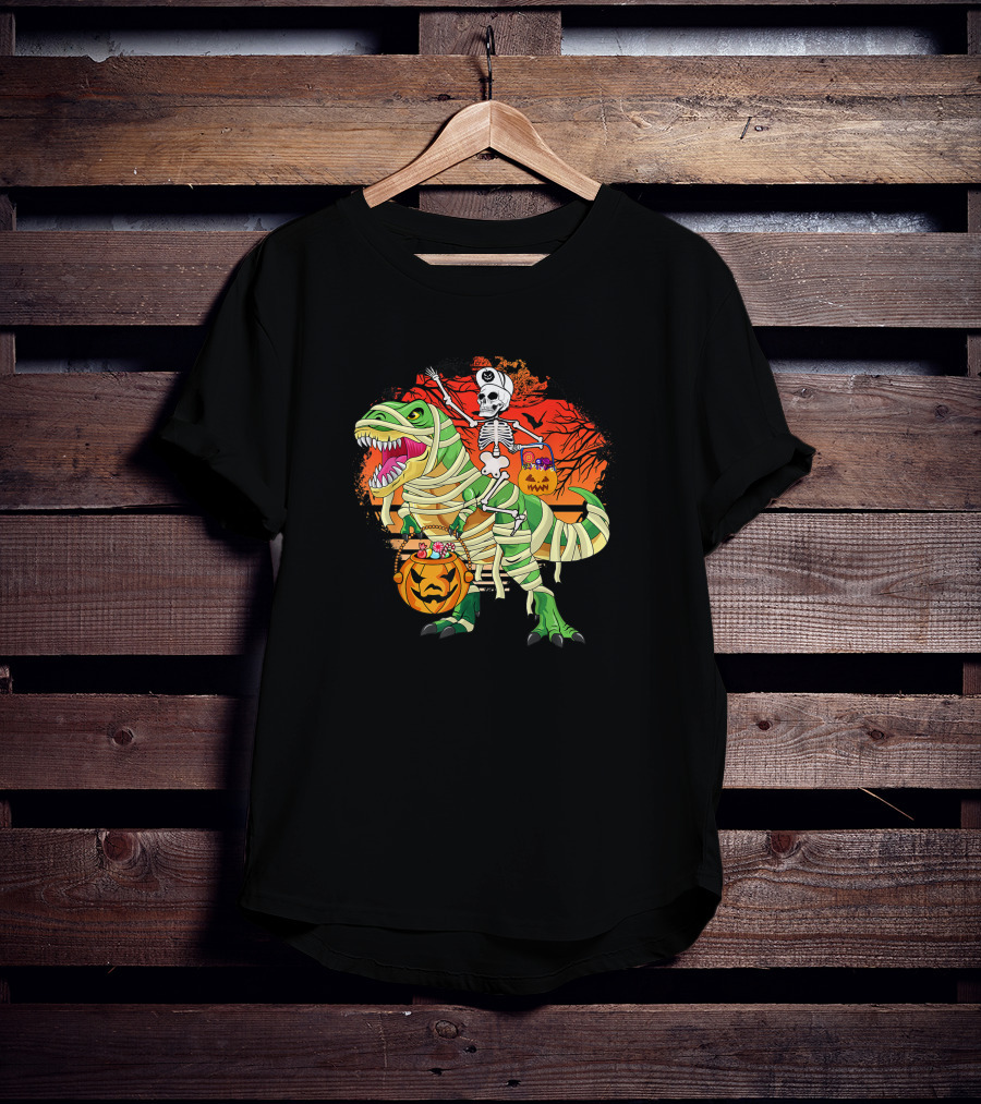 Skeleton Riding Mummy Dinosaur Rex With Halloween Pumpkins On Spooky Background T-Shirt