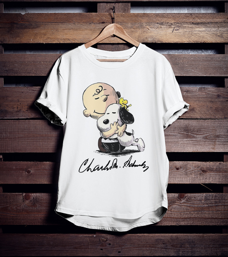 Snoopy And Charlie Brown Hugging By Charles M. Schulz T-Shirt