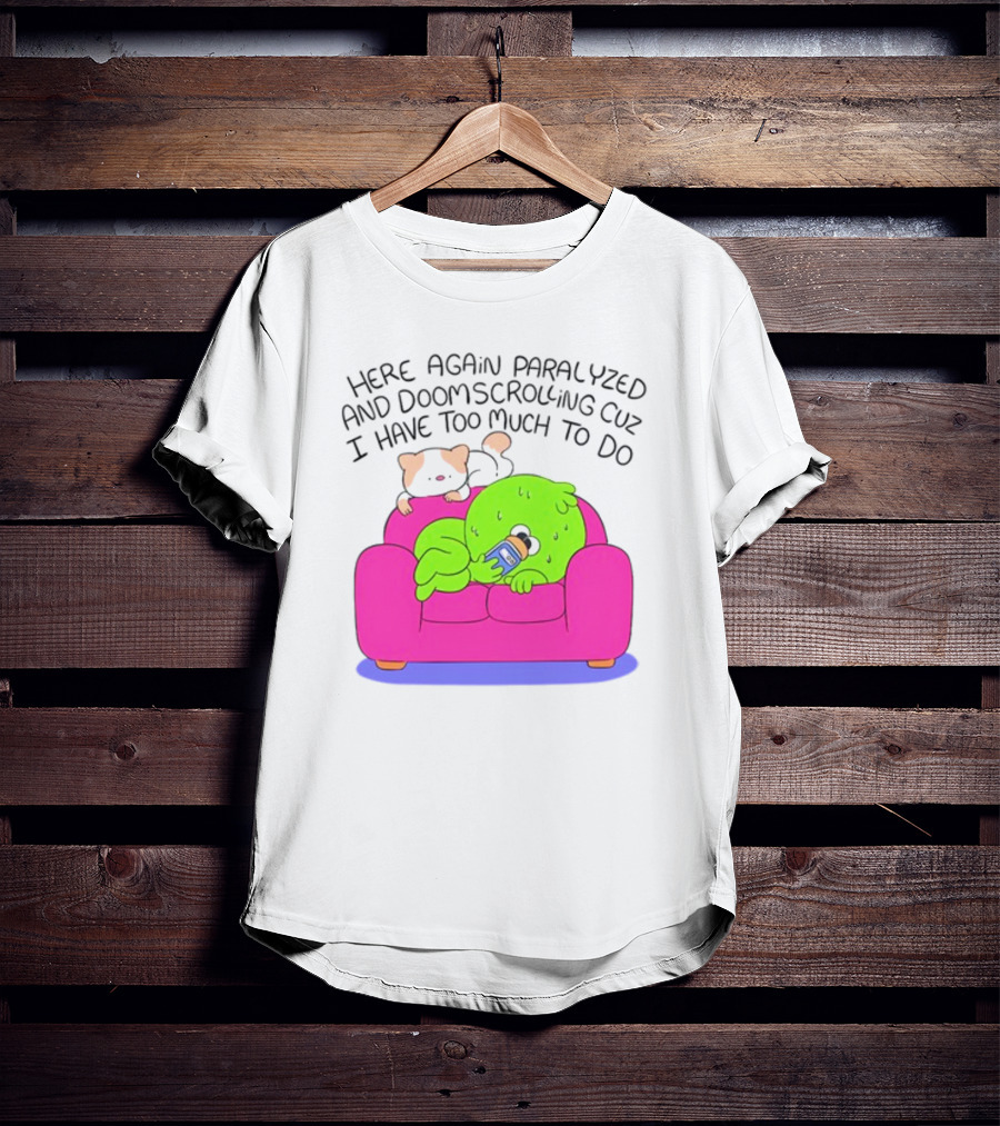Here Again Paralyzed And Doomscrolling Cuz I Have Too Much To Do Quirky Green Figure Relaxing On Pink Couch With Cute Dog T-Shirt