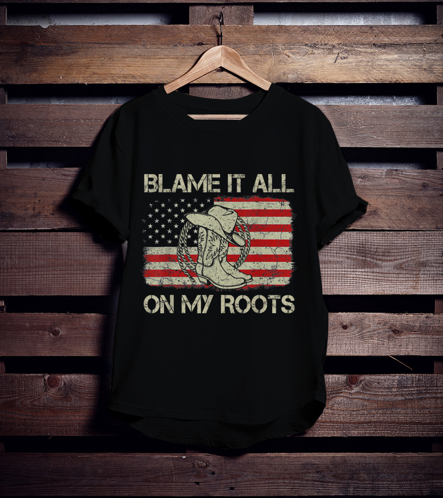 Blame It All On My Roots Cowboy Hat Boots American Flag Background T-Shirt