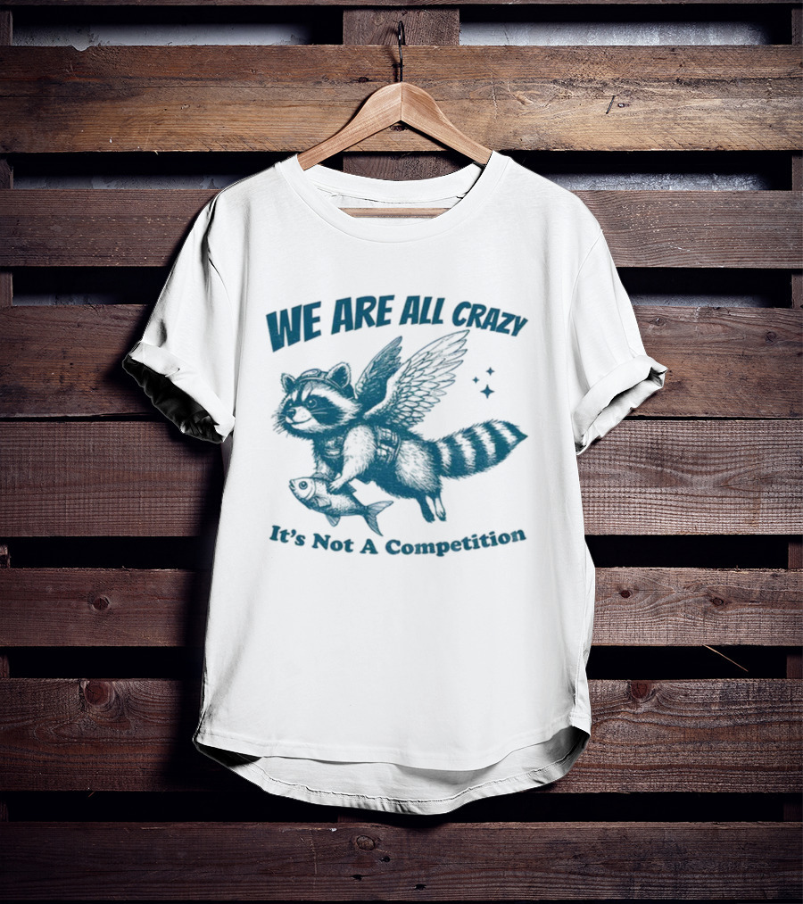 Raccoon With Wings Holding Fish We Are All Crazy It's Not A Competition T-Shirt