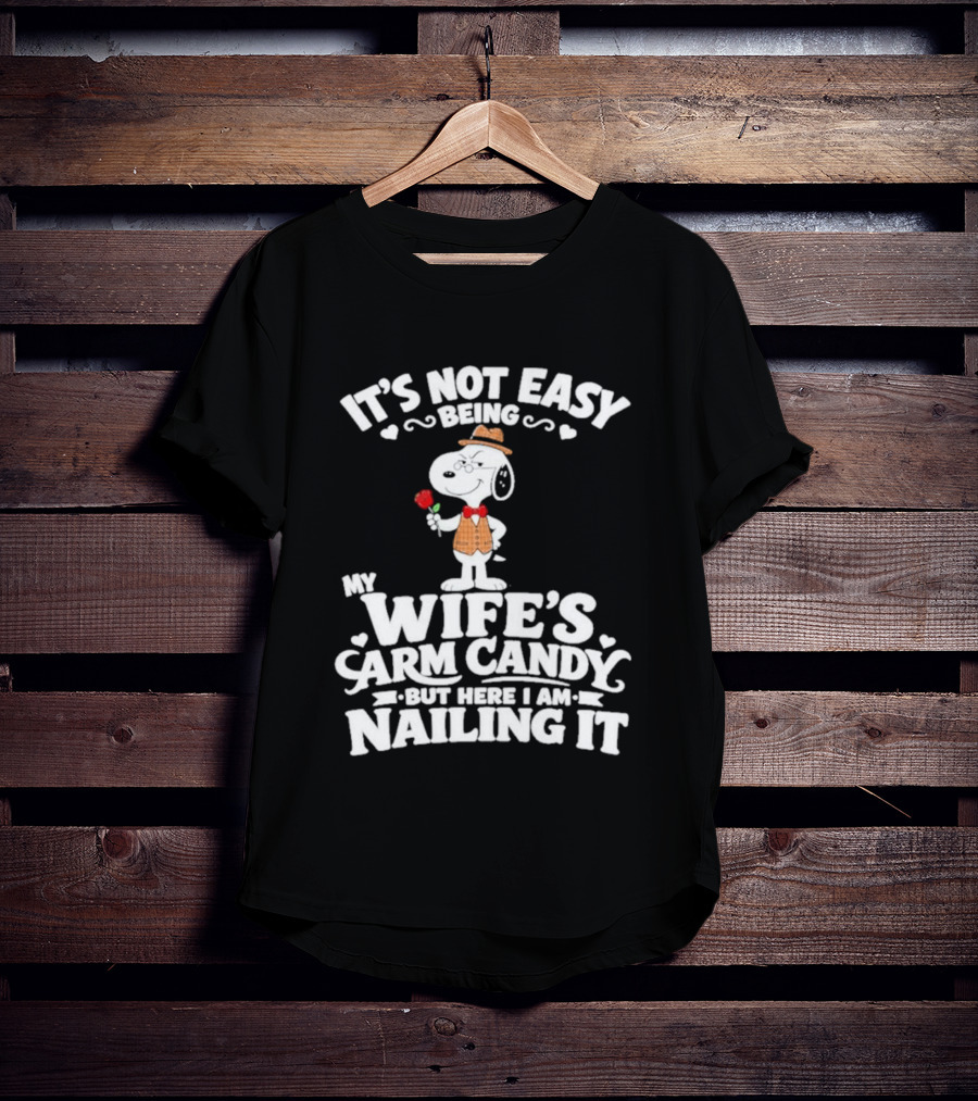 Snoopy It's Not Easy Being My Wife's Arm Candy But Here I Am Nailing It T-Shirt
