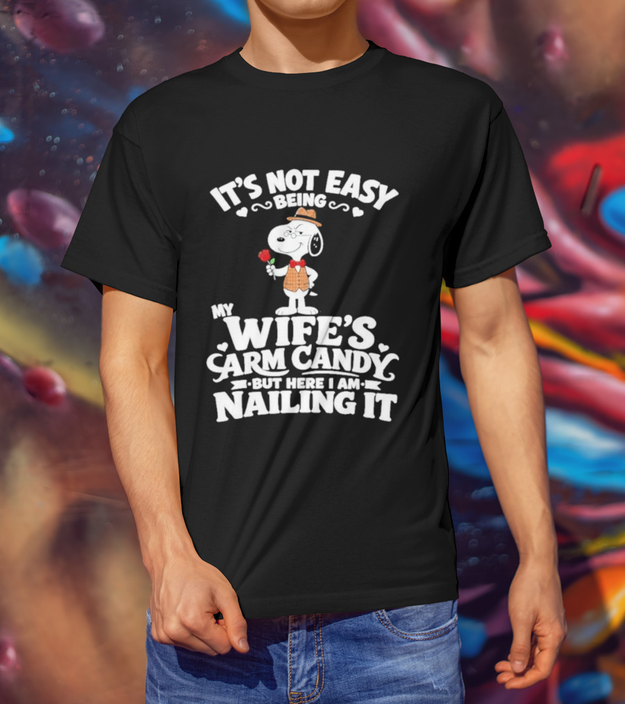 Snoopy It's Not Easy Being My Wife's Arm Candy But Here I Am Nailing It T-Shirt