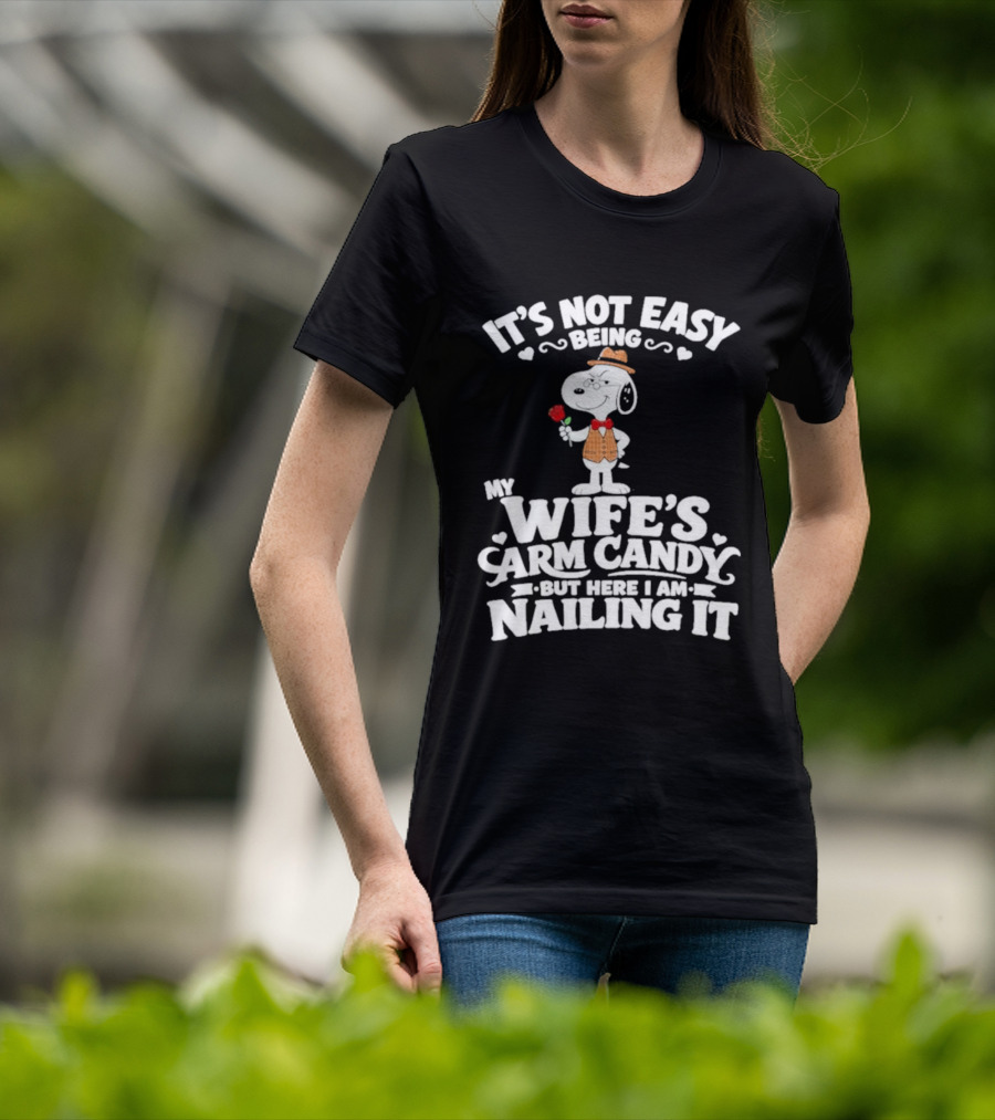 Snoopy It's Not Easy Being My Wife's Arm Candy But Here I Am Nailing It T-Shirt