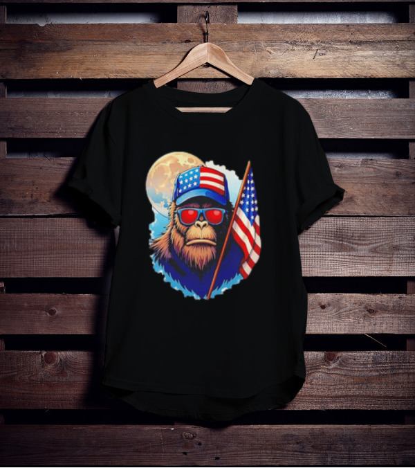 Bigfoot USA Flag Hat Sunglasses Patriotic Moon Background T-Shirt