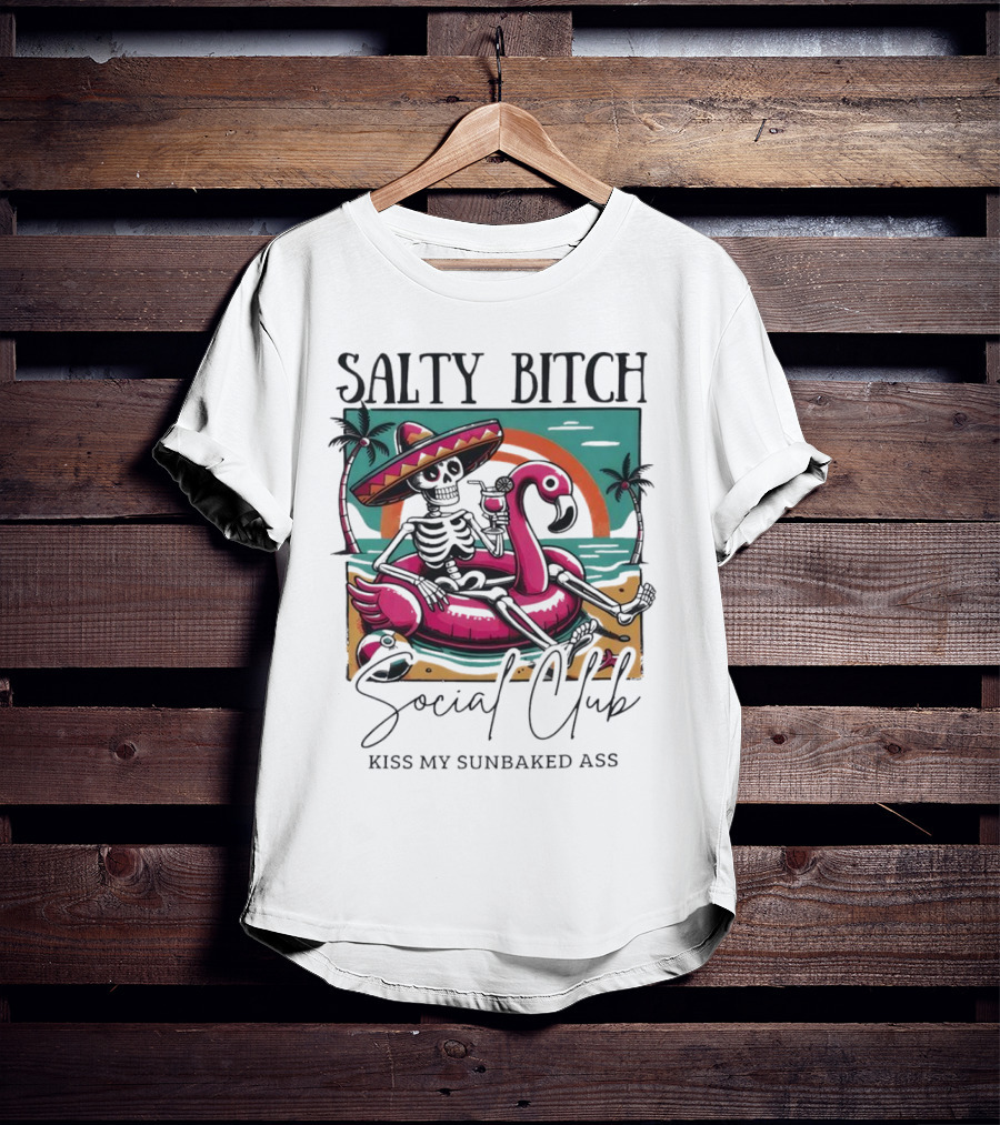 Salty Bitch Skeleton On Flamingo Float In Sunset Beach Scene With Kiss My Sunbaked Ass Text T-Shirt
