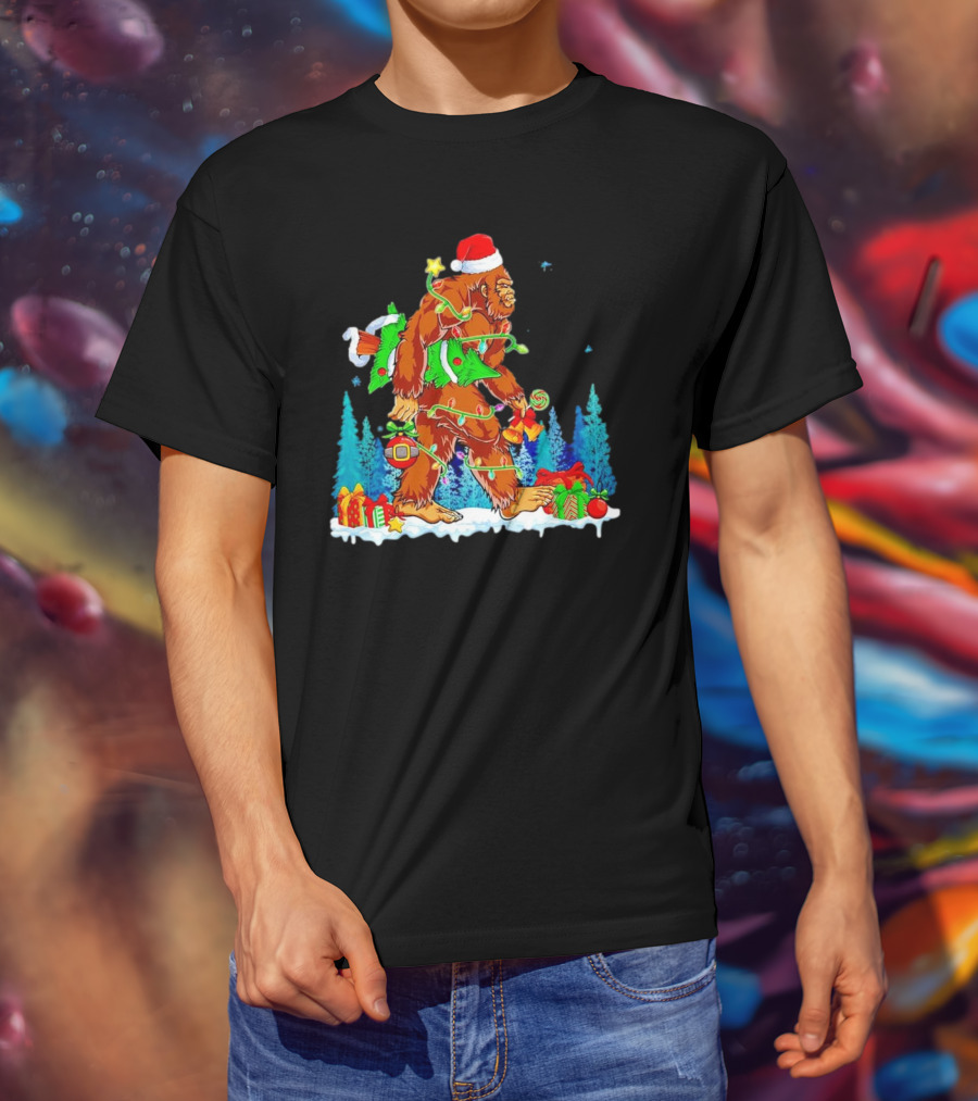 Bigfoot Santa Hugging Christmas Tree With Gifts And Snow Scene T-Shirt