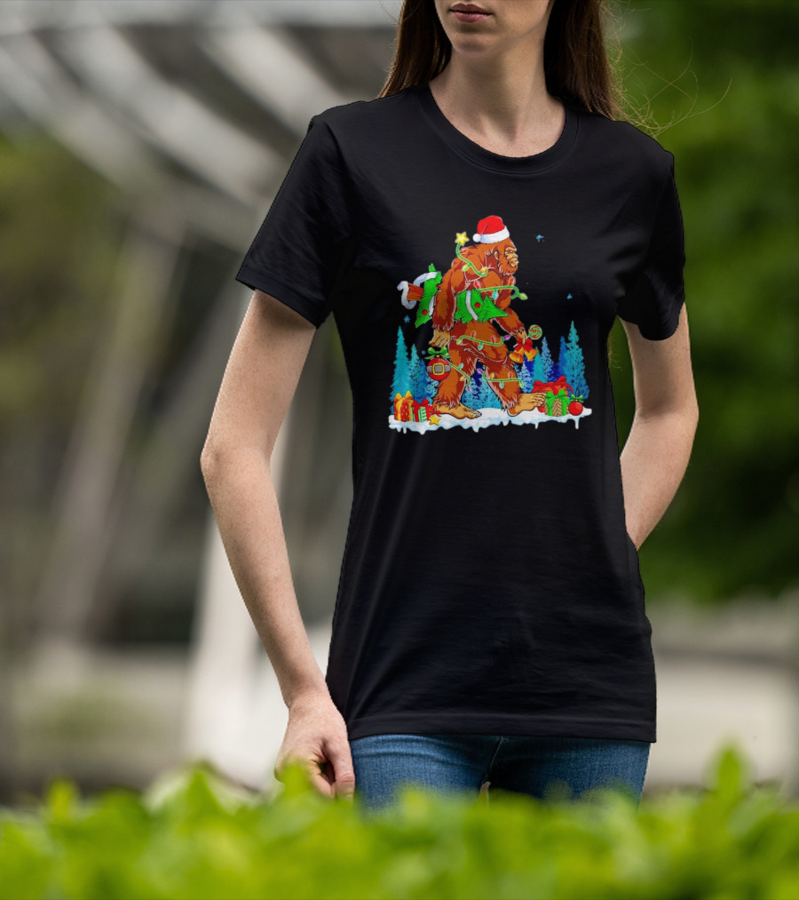 Bigfoot Santa Hugging Christmas Tree With Gifts And Snow Scene T-Shirt