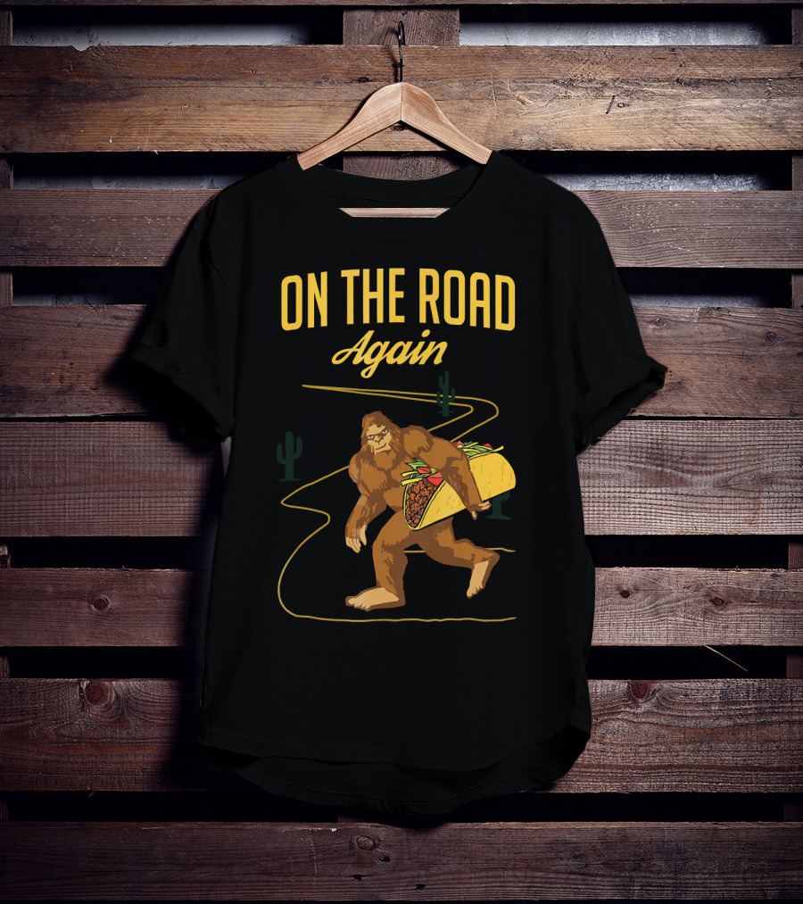 ON THE ROAD AGAIN Smirk Bigfoot Sasquatch Carrying Taco T-Shirt