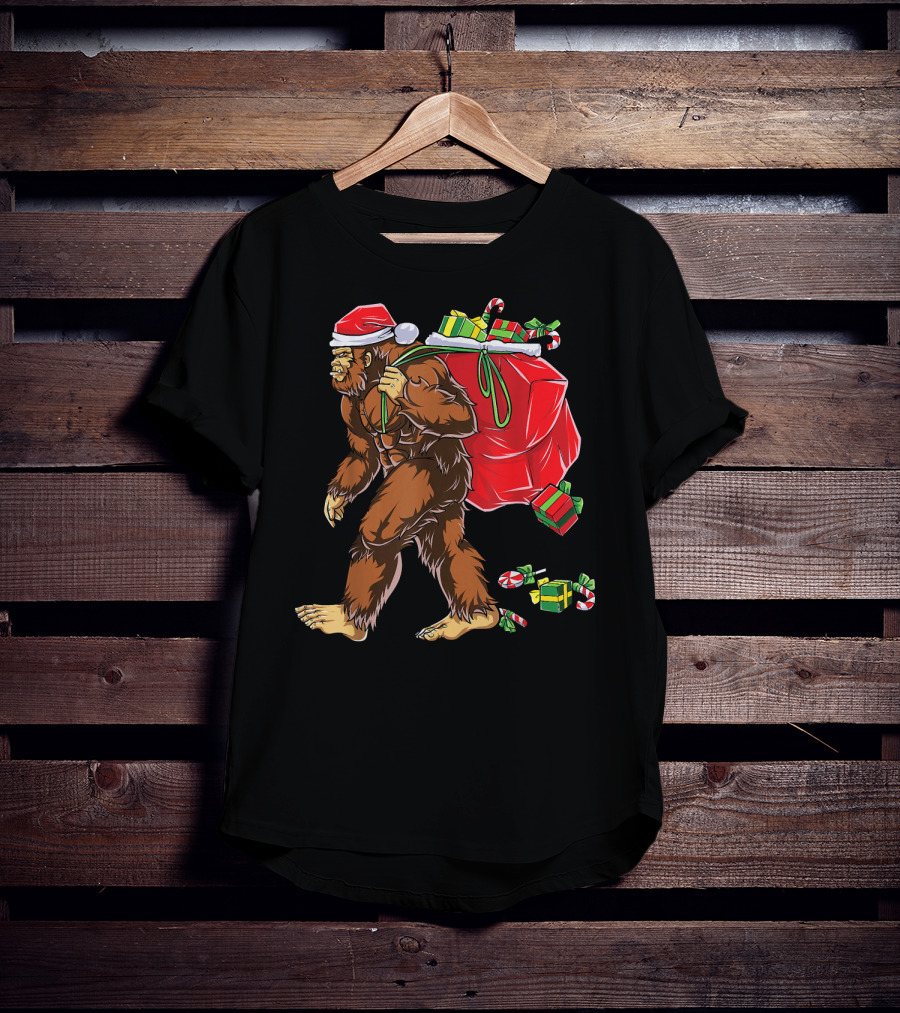 Bigfoot Santa Hat Carrying Christmas Presents And Candy Canes T-Shirt