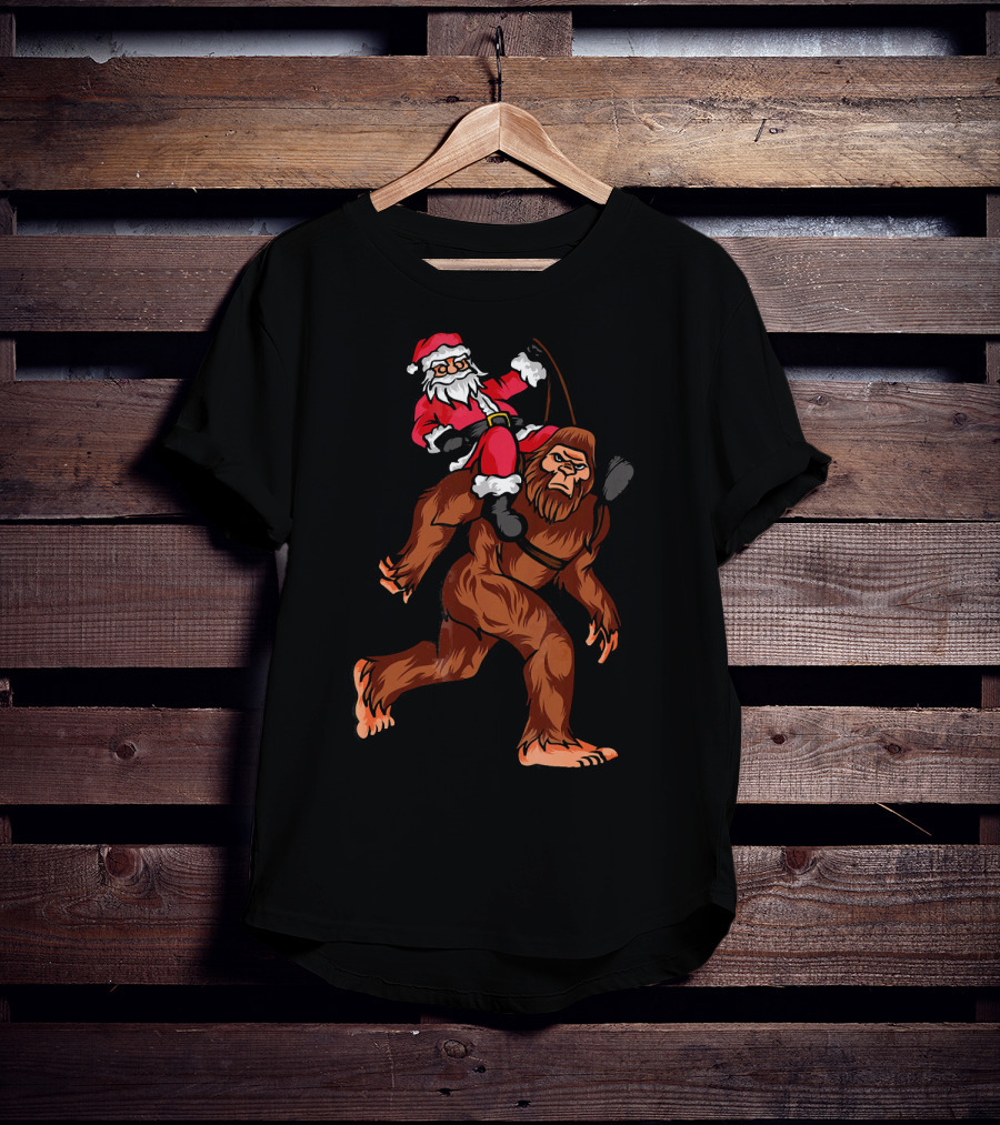 Bigfoot Carrying Santa Claus In Christmas T-Shirt