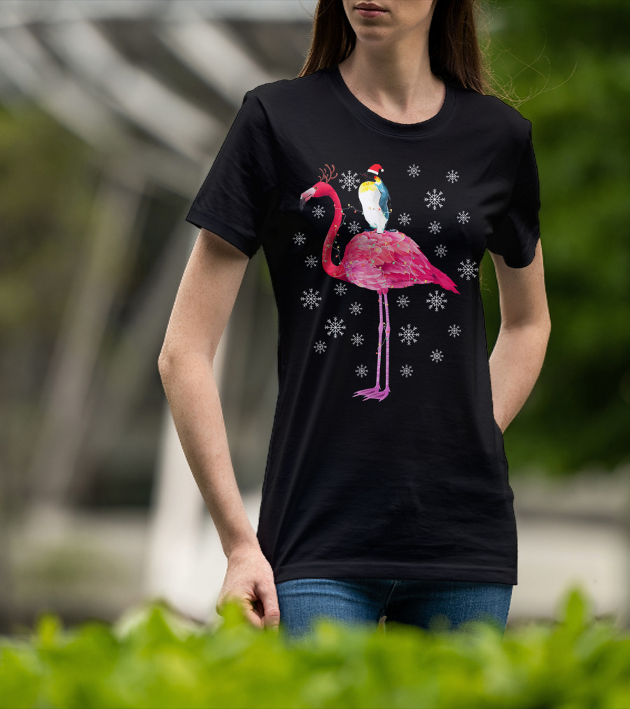 Penguin With Santa Hat Riding Flamingo With Antlers Surrounded By Snowflakes T-Shirt